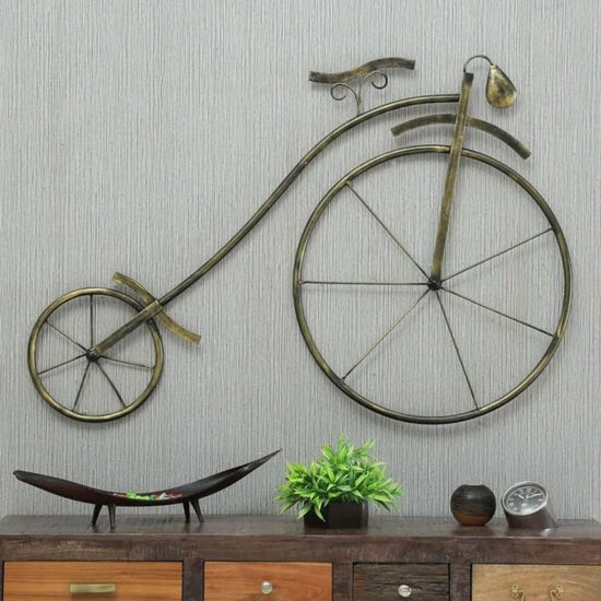 Made from durable metal, this Ancient Cycle Wheel wall art showcases an intricate design that adds a touch of history to any room. 49 x 34. It is the perfect size to be a statement piece or part of a larger gallery wall. Transform your space with this unique and timeless piece. Anti rust powder coating used for long lasting finish and durabilty. Hanging Mechanism Included. Perfect for your living room, bedroom, guest room, hallway, office, reception.